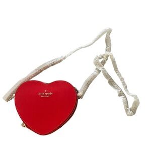 Never used Kate Spade mini heart cross body. Chain crossbody still wrapped.
